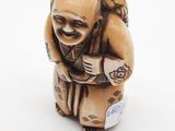 a small figurine of a man with a bag on his back