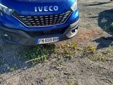 a blue van that is parked in a parking lot
