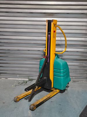 a forklift with a green and yellow fork on it