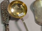 three spoons and a ladle on a table