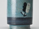 a blue and white vase with a picture of a person on it