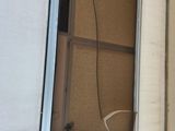 a small window on the side of a white trailer