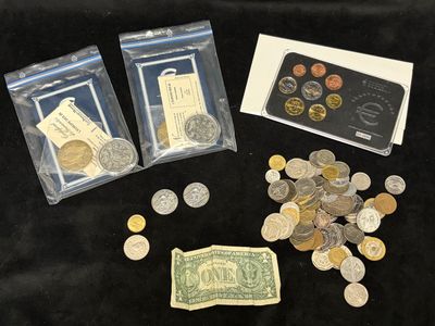 some coins and a card are sitting on a black table
