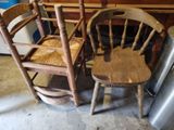 two wooden chairs sitting next to each other in a room