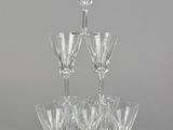 several wine glasses are stacked on top of each other on a table