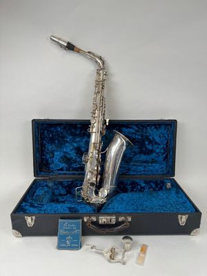 a silver plated saxophone with a blue velvet case and silver keys