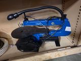 a blue machine that is sitting inside of a cabinet
