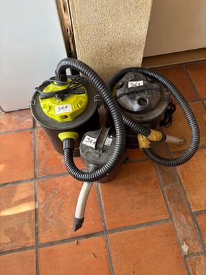 two vacuums sitting on the floor next to each other