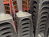 a lot of chairs that are stacked on top of each other