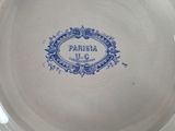 a blue and white plate on a table with a name on it