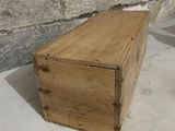 a small wooden box sitting on a table next to a brick wall