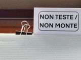 a sign that says non teste / non monte on a binder