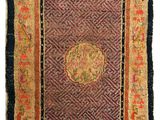 an antique rug with a medallion design on a purple background