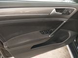 the interior of a car with the door open and the driver ' s seat down