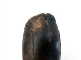 an image of a black vase on a white surface