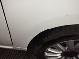 a white car that has a flat tire on it