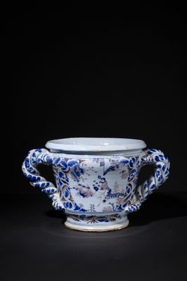 a blue and white cup with dragon handles
