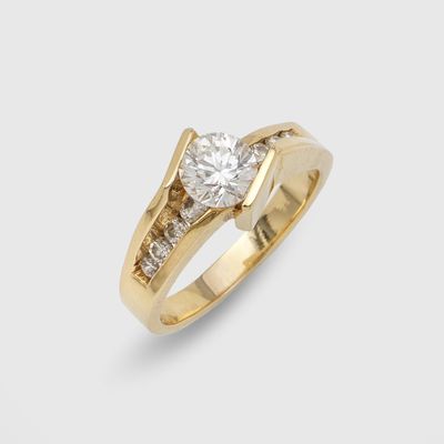 a yellow gold engagement ring with a round brilliant cut diamond