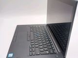 a laptop computer sitting on a table with a keyboard