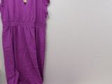 purple dress on a hanger next to a purple shirt on a white table