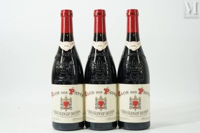 three bottles of red wine sitting next to each other on a white surface