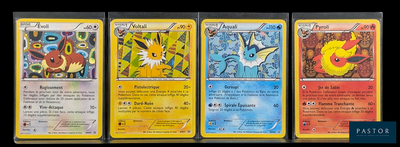 Quatre cartes Pokémon sont alignées les unes à côté des autres sur une surface noire.