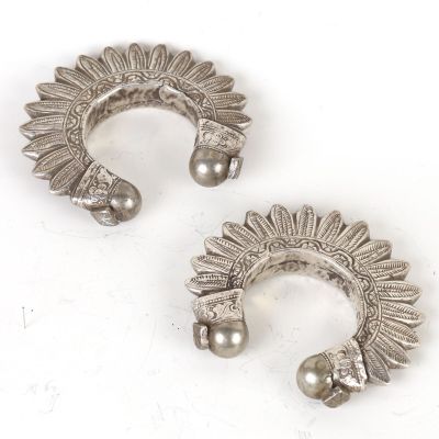 pair of silver plated ear cuffs with a sunflower design