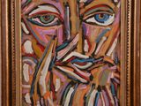 a painting of a man ' s face is shown in a gold frame