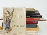 many books stacked on top of each other on a table