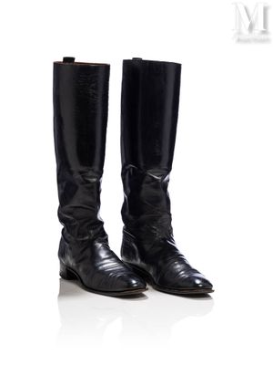 une paire de bottes de cow-boy en cuir noir sur fond blanc