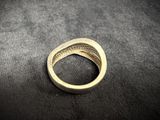 a close up of a gold ring on a black surface