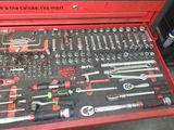 a red tool box filled with tools on the floor