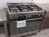a stainless steel stove with a sign on it in a kitchen