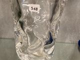 a glass vase on a glass table with a number on it