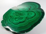 an image of a piece of green agate on a white surface