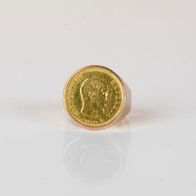 a close up of a gold coin on a white surface