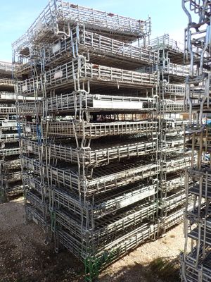 a large pile of metal scaffolding in the middle of a parking lot