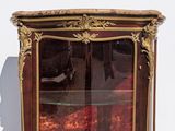 a glass display case with a clock on top of it