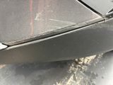 a close up of a car ' s front bumper with a denting on it