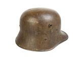 an old helmet with holes on the side of it on a white background