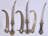 several different types of knives are lined up on a white surface