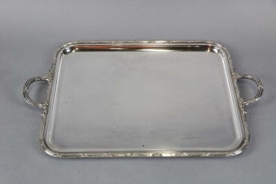 a silver tray with handles and handles on a table