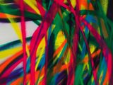 a close up of a painting of colorful lines on a wall
