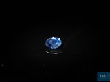 a blue sapphire stone on a black surface