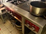 a pot on the stove in the kitchen of a restaurant