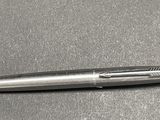 a metal pen that is laying on a table
