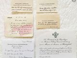 several old letters are sitting on top of a piece of paper