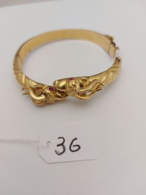 Bracelet or 750° rigide ouvrant avec pierres "tête de bélier…