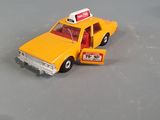 a yellow toy car with a taxi sign on it