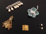 several different types of jewelry are displayed on a black surface